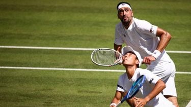Australia's Rinky Hijikata (front) playing with Netherlands' David Pel (rear) eyes the ball as they return it to Britain's Julian Cash and Britain's Lloyd Glasspool during their men's doubles final tennis match on the thirteenth day of the 2025 Wimbledon Championships at The All England Lawn Tennis and Croquet Club in Wimbledon, southwest London, on July 12, 2025. 
HENRY NICHOLLS / AFP