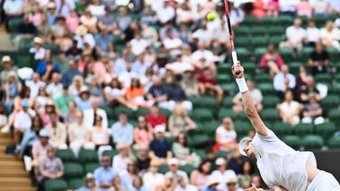 Canada's Denis Shapovalov serves the ball to Russia's Roman Safiullin during their men's singles tennis match on the seventh day of the 2023 Wimbledon Championships at The All England Tennis Club in Wimbledon, southwest London, on July 9, 2023.  
SEBASTIEN BOZON / AFP