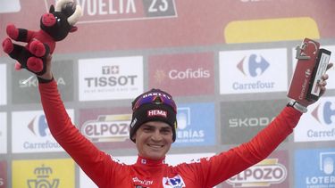 2023-09-13 17:53:10 Team Jumbo-Visma's US rider Sepp Kuss celebrates on the podium reataining the overall leader's red jersy after the stage 17 of the 2023 La Vuelta cycling tour of Spain, a 124,4 km race between Ribadesella and Alto de l'Angliru on September 13, 2023. 
MIGUEL RIOPA / AFP