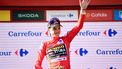 2023-09-09 17:56:57 Team Jumbo-Visma's US rider Sepp Kuss wearing the overall leader's red jersey celebrates on the podium after the stage 14 of the 2023 La Vuelta cycling tour of Spain, a 156,2 km race between Sauveterre-de-Bearn and Larra Belagua, on September 9, 2023. 
Ander GILLENEA / AFP