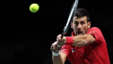 Serbia's Novak Djokovic returns the ball against Italy's Jannik Sinner during the second men's singles semifinal tennis match between Italy and Serbia of the Davis Cup tennis tournament at the Martin Carpena sportshall, in Malaga on November 25, 2023. 
LLUIS GENE / AFP