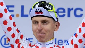 epa11470452 Slovenian rider Tadej Pogacar of UAE Team Emirates celebrates on the podium wearing the best climber's Polka Dot jersey following the end of the eleventh stage of the 2024 Tour de France cycling race over 211km from Evaux-les-Bains to Le Lioran, France, 10 July 2024.  EPA/GUILLAUME HORCAJUELO