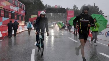 People leave after a heavy hailstorm hit the finish area of the third stage of the Vuelta a Espana 2026, a 174 km race between Gruissan and Font-Romeu on August 24, 2026.   Stage three of the Vuelta a Espana was abandoned inside the final few kilometres because of a dangerous hailstorm today. Riders, including red jersey-wearing race leader Tadej Pogacar, pulled off the road to take shelter in a hotel amid the severe weather conditions. Mats Wenzel and Lorenzo Fortunato had been leading ahead of the peloton when the decision was made.
Ed JONES / AFP