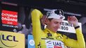UAE Team Emirates XRG's Slovenian rider Tadej Pogačar celebrates wearing the overall leader's yellow jersey on the podium of the 7th stage of the 77th edition of the Criterium du Dauphine cycling race, 131,6 km between Grand-Aigueblanche and Valmeinier, on June 14, 2025. 
Anne-Christine POUJOULAT / AFP