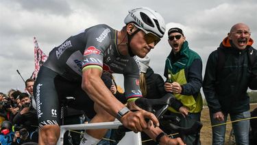 Alpecin-Deceuninck's Dutch rider Mathieu van der Poel cycles in a breakaway leading the race at the Carrefour de l'Arbre, a cobblestone road, during the 122nd edition of the Paris-Roubaix one-day classic cycling race, 259,2 km between Compiegne and Roubaix, northern France on April 13, 2025. 
Jeff PACHOUD / AFP