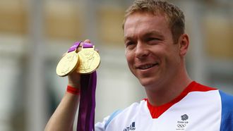 Britain's champion Olympic cyclist Chris Hoy poses with his gold medals during a parade celebrating Britain's athletes who competed in the London 2012 Olympic and Paralympic Games in central London on September 10, 2012. Britain was bidding a fond farewell om September 10 to a golden summer of Olympic and Paralympic sport with a victory parade by athletes through London ending up at Buckingham Palace.  AFP PHOTO / POOL / PAUL GILHAM