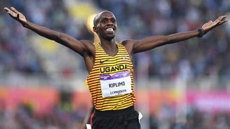 Uganda's Jacob Kiplimo celebrates winning and taking the gold medal in the men's 5000m final athletics event at the Alexander Stadium, on day nine of the Commonwealth Games in Birmingham, central England, on August 6, 2022. 
Glyn KIRK / AFP