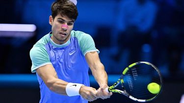 epa11718649 Carlos Alcaraz of Spain hits a backhand during his Round Robin match against Andrey Rublev of Russia at the Nitto ATP Finals in Turin, Italy, 13 November 2024.  EPA/ALESSANDRO DI MARCO