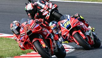 Ducati Lenovo Team's Spanish MotoGP rider Marc Marquez (L) and Honda HRC Castrol team's Spanish MotoGP rider Joan Mir (R) take a corner during the MotoGP class race of the MotoGP Japanese Grand Prix at the Mobility Resort Motegi in Motegi, Tochigi prefecture on September 28, 2025. 
Toshifumi KITAMURA / AFP