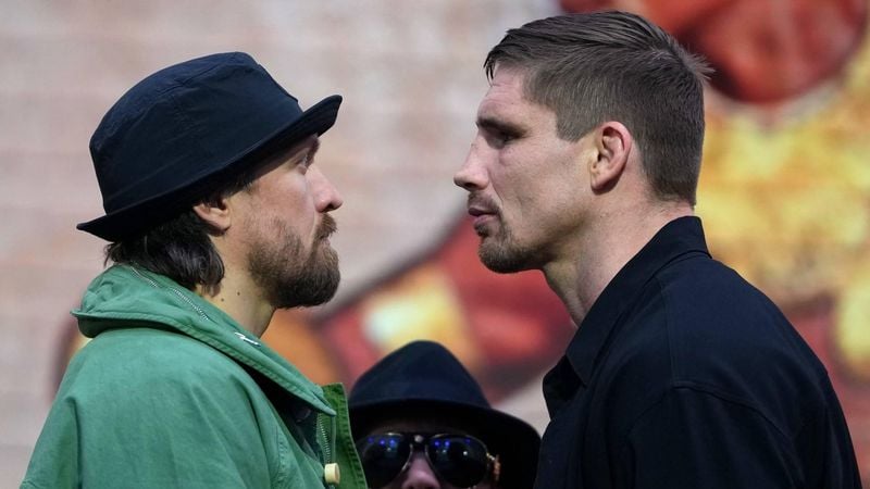 Ukraine's Oleksandr Usyk faces off with Netherlands' Rico Verhoeven (R) during a press conference, in east London on April 14, 2026, ahead of their WBC World Heavyweight Championship 'Glory in Giza' boxing match, taking place on May 23, 2026 in Egypt. 
CARLOS JASSO / AFP
