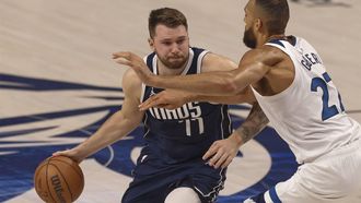 epa11372728 Dallas Mavericks guard Luka Doncic (L) dribbles past Minnesota Timberwolves center Rudy Gobert (R) during the first half of the NBA Western Conference Finals playoff game three between the Minnesota Timberwolves and the Dallas Mavericks in Dallas, Texas, USA, 26 May 2024.  EPA/ADAM DAVIS SHUTTERSTOCK OUT