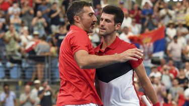 Novak Djokovic of Serbia (R) celebrates with team captain Nenad Zimonjic (L) after winning his men's singles match against Denis Shapovalov of Canada at the ATP Cup tennis tournament in Sydney on January 10, 2020. 
William WEST / AFP