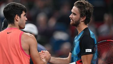 Czech Republic's Tomas Machac (R) shakes hands after winning against Spain’s Carlos Alcaraz during their men's singles match at the Shanghai Masters tennis tournament in Shanghai on October 10, 2024. 
HECTOR RETAMAL / AFP
