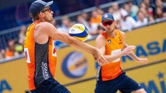 Netherland's Robert Meeuwsen and Netherland's Alexander Brouwer play the ball during the men's semi-finals of the Beach Volleyball Team European Championship match between Netherland and Norway in Vienna, Austria on August 6, 2022. 
GEORG HOCHMUTH / APA / AFP