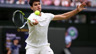 Spain's Carlos Alcaraz returns against France's Ugo Humbert during their men's singles fourth round tennis match on the seventh day of the 2024 Wimbledon Championships at The All England Lawn Tennis and Croquet Club in Wimbledon, southwest London, on July 7, 2024. 
HENRY NICHOLLS / AFP