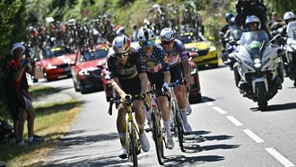 Team Visma - Lease a bike team's Belgian rider Wout van Aert (L), Lidl - Trek team's US rider Quinn Simmons (C) and Alpecin - Deceuninck team's Dutch rider Mathieu van der Poel cycle in a chasing group during the 11th stage of the 112th edition of the Tour de France cycling race, 156.8 km starting and finishing in Toulouse, southwestern France, on July 16, 2025. 
Loic VENANCE / AFP