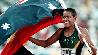 1997-08-04 21:56:00 (FILES) Picture dated 04 August 1997 shows Cathy Freeman of Australia carrying the Australian and the Aborigine flags after winning the women's 400m final at the Athens '97 World Championships in Athletics. The Olympic 400m champion is unlikely to defend her title at the world athletics championships in Edmonton in August.  However, Chris Giannapoulos, speaking for her agents, IMG, 12 March 2001, denied the Aboriginal runner was pregnant, saying she is definately not retiring, and she is not pregnant, we are monitoring her fitness and a decision on whether she will run this year will be made at the end of the week, he told AFP.   AFP PHOTO 
LOUISA GOULIAMAKI / AFP FILES / AFP