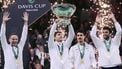 Italy's Flavio Cobolli (C), next to Italy's team captain Filippo Volandri (L) and Italy's Matteo Berrettini (R), lifts the David Cup trophy after their victory over Spain in their 2025 Davis Cup men's single final tennis match at the Super Tennis Arena in Bologna, northen Italy, on November 23, 2025. 
Tiziana FABI / AFP