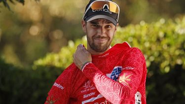 2023-02-12 13:09:46 epa10462910 Spanish rider Jesus Herrada of Cofidis team celebrates on the podium wearing the overall leader's red jersey after winning the 2nd stage of the Tour of Oman cycling race over 174 km from Sultan Qaboos Sports Complex to Qurayyat, Oman, 12 February 2023.  EPA/YOAN VALAT