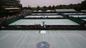 Outer courts are covered after a persistent rain started and stopped all outdoor play on day four of the 2013 Wimbledon Championships tennis tournament at the All England Club in Wimbledon, southwest London, on June 27, 2013. Rain forced the abandonment of play at Wimbledon on June 27 apart from centre court where they deployed the roof. AFP PHOTO / CARL COURT -  RESTRICTED TO EDITORIAL USE
CARL COURT / AFP