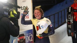 epa11120972 Kimberley Bos of Netherlands celebrates after finishing the women's Skeleton race at the IBSF Bob & Skeleton World Cup in Sigulda, Latvia, 02 February 2024.  EPA/TOMS KALNINS