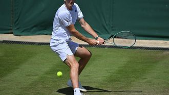 Poland's Hubert Hurkacz returns against France's Arthur Fils during their men's second round singles tennis match on the fourth day of the 2024 Wimbledon Championships at The All England Lawn Tennis and Croquet Club in Wimbledon, southwest London, on July 4, 2024. 
ANDREJ ISAKOVIC / AFP