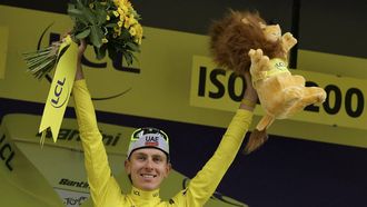 UAE Team Emirates team's Slovenian rider Tadej Pogacar celebrates on the podium with the overall leader's yellow jersey after the 19th stage of the 111th edition of the Tour de France cycling race, 144,6 km between Embrun and Isola 2000, in the French Alps, on July 19, 2024. 
Thomas SAMSON / AFP