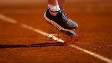 A photo shows the shoes of France's Leolia Jeanjean as she hits a return in her women's singles match against Hungary’s Amarissa Kiara Toth during the Billie Jean King Cup play-offs between France and Hungary, at Oeiras outskirts of Lisbon, on April 10, 2026. 
FILIPE AMORIM / AFP