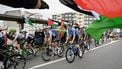 Pro-Palestinian protesters wave flags and shout as the peloton rides by in Poio at the start of the 16th stage of the Vuelta a Espana, a 172 km race between Poio and Castro de Herville, on September 9, 2025.   
Miguel RIOPA / AFP