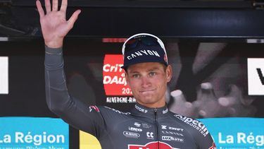 Alpecin-Deceuninck's Dutch rider Mathieu van der Poel celebrates winning the combativity award on the podium of the 8th and final stage of the 77th edition of the Criterium du Dauphine cycling race, 133,3 km between Val-d'Arc and Val-Cenis - Plateau du Mont Cenis, on June 15, 2025. 
Anne-Christine POUJOULAT / AFP