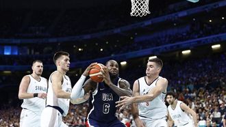 USA's #06 LeBron James attempts to go to the basket past Serbia's #03 Filip Petrusev (L) and Serbia's #09 Vanja Marinkovic in the men's preliminary round group C basketball match between Serbia and USA during the Paris 2024 Olympic Games at the Pierre-Mauroy stadium in Villeneuve-d'Ascq, northern France, on July 28, 2024. 
Sameer Al-Doumy / AFP