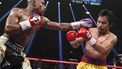 Floyd Mayweather Jr. exchange punches with Manny Pacquiao during their welterweight unification championship bout, May 2, 2015 at MGM Grand Garden Arena in Las Vegas, Nevada.  Mayweather defeated Pacquiao by unanimous decision.  AFP PHOTO / JOHN GURZINKSI 
JOHN GURZINSKI / AFP