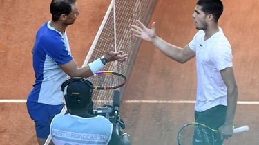 Spain's Rafael Nadal shakes hands with Spain's Carlos Alcaraz after their 2022 ATP Tour Madrid Open tennis tournament singles quarter-final match at the Caja Magica in Madrid on May 6, 2022. 
OSCAR DEL POZO / AFP