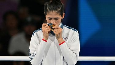 Gold medallist Taiwan's Lin Yu-ting celebrates on the podium during the medal ceremony for the women's 57kg final boxing category during the Paris 2024 Olympic Games at the Roland-Garros Stadium, in Paris on August 10, 2024. 
MOHD RASFAN / AFP