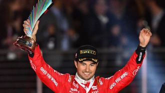 2023-11-19 08:02:17 Red Bull Racing's Mexican driver Sergio Perez celebrates with the trophy on the podium after placing third in the Las Vegas Formula One Grand Prix on November 18, 2023, in Las Vegas, Nevada.  
ANGELA WEISS / AFP