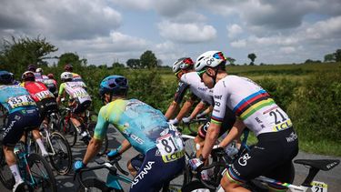 XDS Astana Team's Colombian rider Sergio Andres Higuita Garcia (C) and UAE Team Emirates XRG's Slovenian rider Tadej Pogačar (R) cycle with the pack of riders during the 1st stage of the 77th edition of the Criterium du Dauphine cycling race, 195,8 km between Domérat and Montlucon, on June 8, 2025. 
Anne-Christine POUJOULAT / AFP