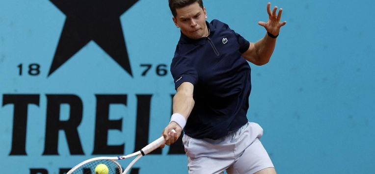 Belgium's Alexander Blockx returns the ball to Canada's Felix Auger-Aliassime during their 2026 ATP Tour Madrid Open tennis tournament third round singles match at the Caja Magica in Madrid, on April 27, 2026.  
OSCAR DEL POZO / AFP