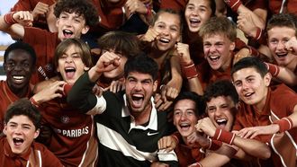 Spain's Carlos Alcaraz celebrates with ball boys and girls after winning against Italy's Jannik Sinner at the end of their men's singles final match on day 15 of the French Open tennis tournament on Court Philippe-Chatrier at the Roland-Garros Complex in Paris on June 8, 2025. 
Thibaud MORITZ / AFP