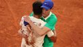 epa12164558 Carlos Alcaraz of Spain celebrates winning his Men's final match as he hugs Jannik Sinner of Italy at the French Open Grand Slam tennis tournament at Roland Garros in Paris, France, 08 June 2025.  EPA/TERESA SUAREZ