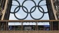 The Olympic rings are seen on the structure of the landmark as people walk on the first floor of The Eiffel Tower in Paris on July 24, 2024, ahead of the Paris 2024 Olympic Games. 
MAURO PIMENTEL / AFP