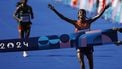 epa11544617 Sifan Hassan of the Netherlands (R) crosses the finishing line to win the Women's Marathon event of the Athletics competitions as Tigst Assefa (L) of Ethiopia follows in second in the Paris 2024 Olympic Games in Paris, France, 11 August 2024.  EPA/YOAN VALAT