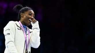 2023-10-06 22:15:28 Winner US' Simone Biles celebrates on the podium after the Women's Individual All-Around Final during the 52nd FIG Artistic Gymnastics World Championships, in Antwerp, northern Belgium, on October 6, 2023. 
Lionel BONAVENTURE / AFP