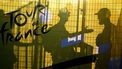Attendees are silhouetted behind a banner bearing the Tour de France logo during the team presentation for the 111th edition of the Tour de France cycling race, in Florence in Italy, on June 27, 2024. 
Marco BERTORELLO / AFP