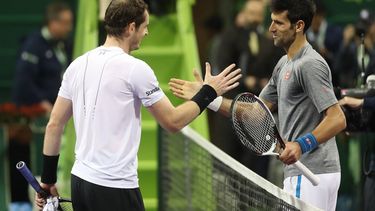 Britain's Andy Murray (L) congratulates Serbia's Novak Djokovic on winning during their final tennis match at the ATP Qatar Open in Doha on January 7, 2017. 
KARIM JAAFAR / AFP