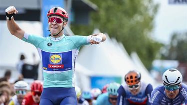 Lidl-Trek team's Italian rider Jonathan Milan (L) celebrates as he crosses the finish line to win the third stage of the 