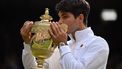 Spain's Carlos Alcaraz kisses the winner's trophy as he poses for pictures following his victory against Serbia's Novak Djokovic during their men's singles final tennis match on the fourteenth day of the 2024 Wimbledon Championships at The All England Lawn Tennis and Croquet Club in Wimbledon, southwest London, on July 14, 2024. Defending champion Alcaraz beat seven-time winner Novak Djokovic in a blockbuster final, with Alcaraz winning 6-2, 6-2, 7-6.
ANDREJ ISAKOVIC / AFP
