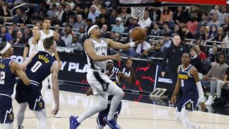 epa11223392 San Antonio Spurs forward Keldon Johnson (C) makes a layup during the second half of an NBA game between the San Antonio Spurs and the Denver Nuggets in Austin, Texas, USA, 15 March 2024.  EPA/ADAM DAVIS SHUTTERSTOCK OUT