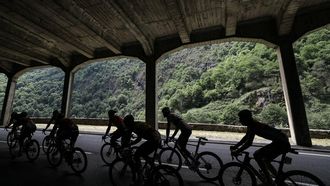 Riders are silhouetted as they cycle through a mountain tunnel in the ascent of Col du Tourmalet during the 14th stage of the 111th edition of the Tour de France cycling race, 151,9 km between Pau and Saint-Lary-Soulan Pla d'Adet, in the Pyrenees mountains in southwestern France, on July 13, 2024. 
Thomas SAMSON / AFP