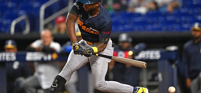Curacao's outfielder #10 Jurickson Profar misses a shot during the Caribbean Series baseball game between Curacao and Mexico at LoanDepot Park in Miami, Florida, on February 1, 2024. 
CHANDAN KHANNA / AFP