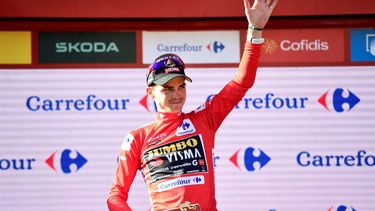 2023-09-09 17:56:57 Team Jumbo-Visma's US rider Sepp Kuss wearing the overall leader's red jersey celebrates on the podium after the stage 14 of the 2023 La Vuelta cycling tour of Spain, a 156,2 km race between Sauveterre-de-Bearn and Larra Belagua, on September 9, 2023. 
Ander GILLENEA / AFP
